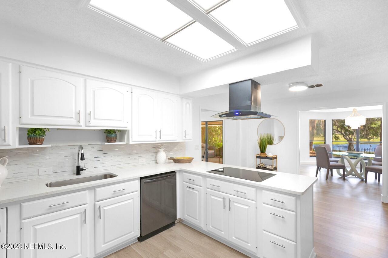 4309 Monument Road Jacksonville, FL 32225 - Photo 26 of 65 a kitchen with a sink stove and cabinets