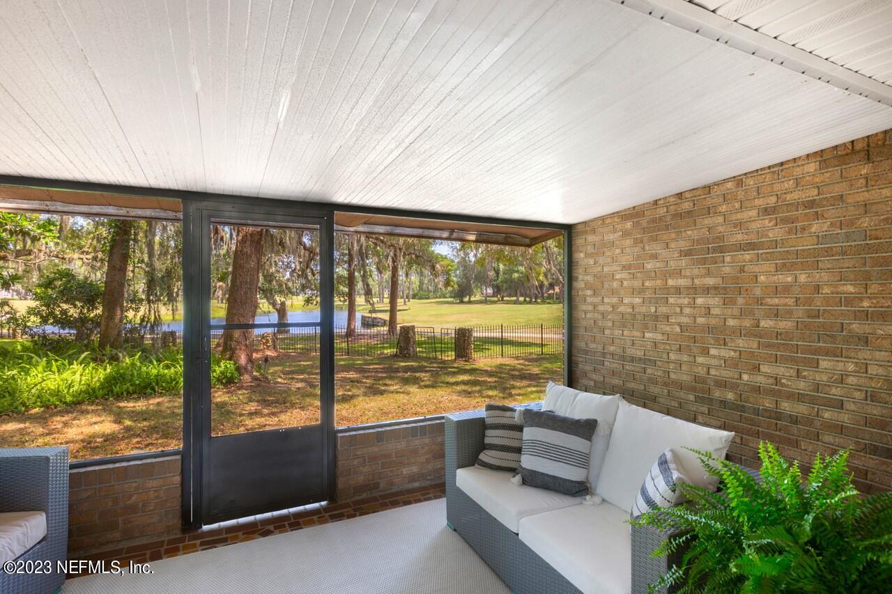 4309 Monument Road Jacksonville, FL 32225 - Photo 32 of 65 view of living room with furniture and floor to ceiling window