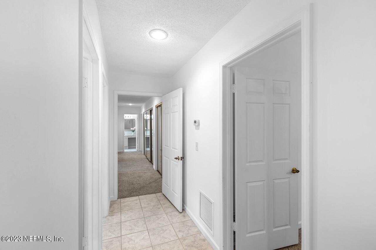 4309 Monument Road Jacksonville, FL 32225 - Photo 34 of 65 a view of a hallway with wooden shelves