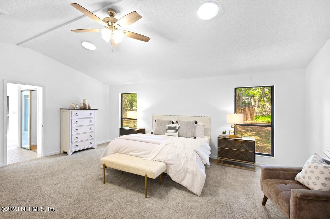 4309 Monument Road Jacksonville, FL 32225 - Photo 37 of 65 a bedroom with a bed and a couch