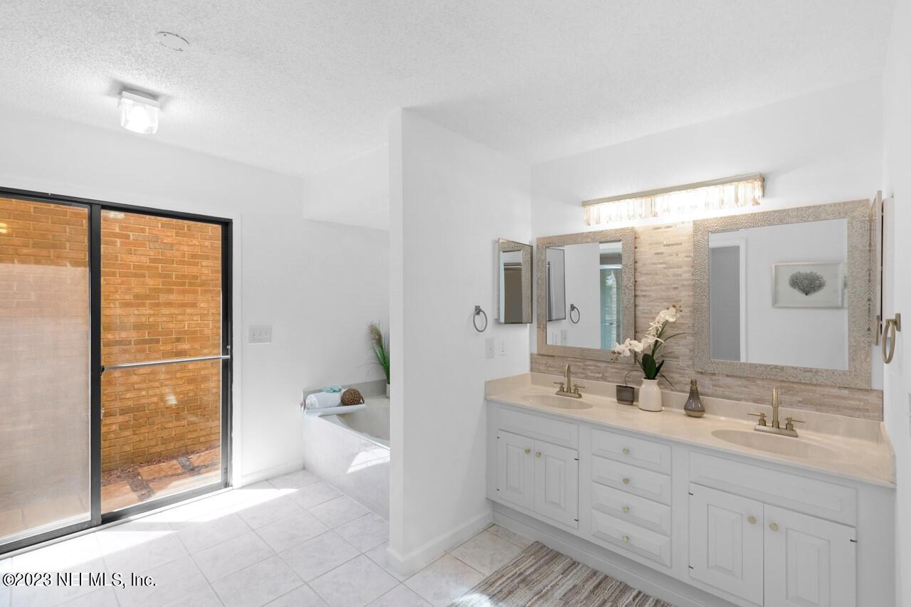 4309 Monument Road Jacksonville, FL 32225 - Photo 40 of 65 a bathroom with a double vanity sink toilet and shower
