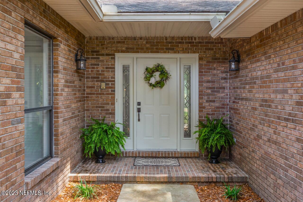 4309 Monument Road Jacksonville, FL 32225 - Photo 4 of 65 a front view of a house with potted plants
