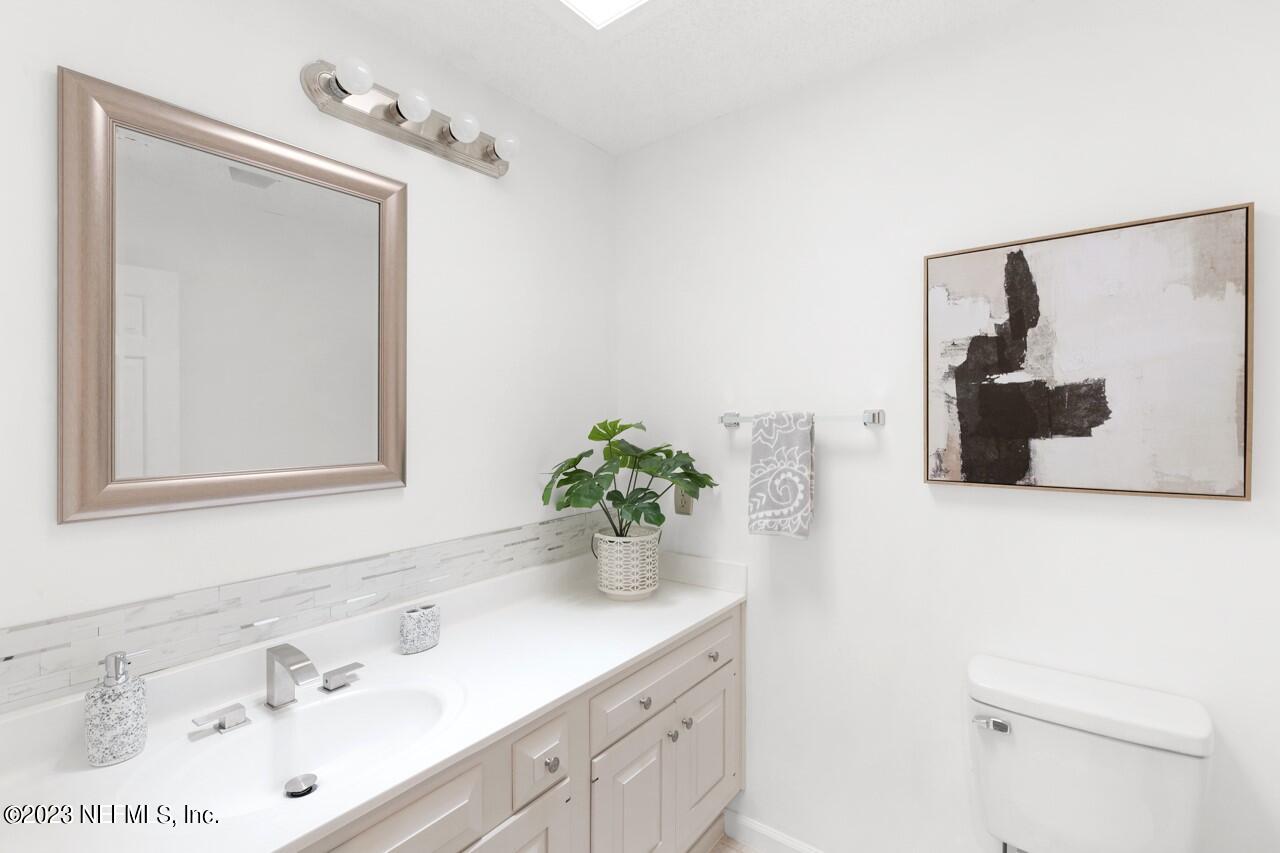 4309 Monument Road Jacksonville, FL 32225 - Photo 50 of 65 a bathroom with a sink and a mirror
