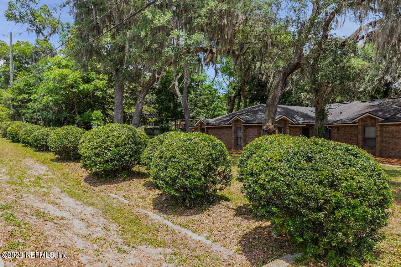 4309 Monument Road Jacksonville, FL 32225 - Photo 55 of 65 a backyard of a house with lots of green space