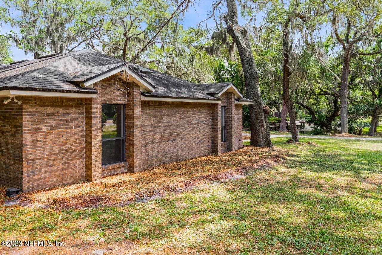 4309 Monument Road Jacksonville, FL 32225 - Photo 59 of 65 a front view of a house with a yard and garage