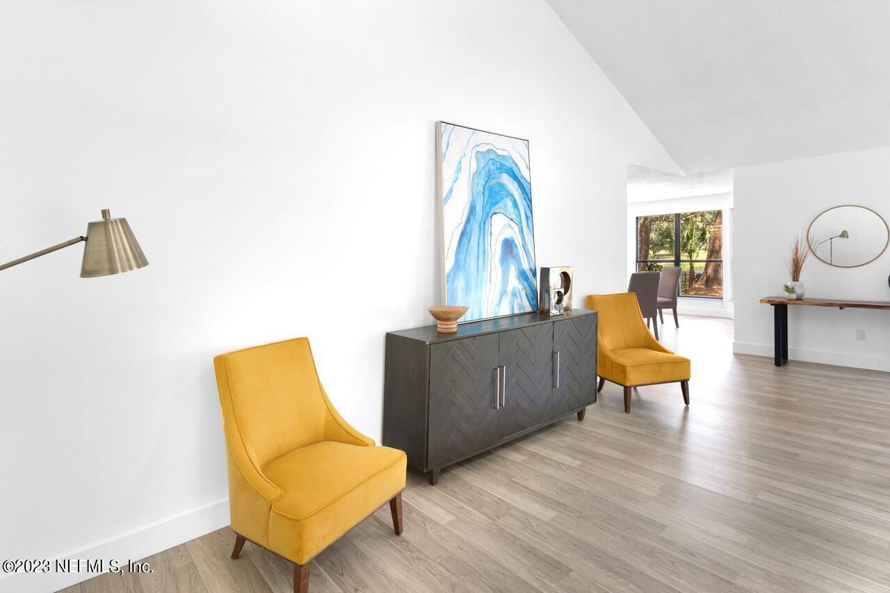 4309 Monument Road Jacksonville, FL 32225 - Photo 8 of 65 a living room with furniture and wooden floor