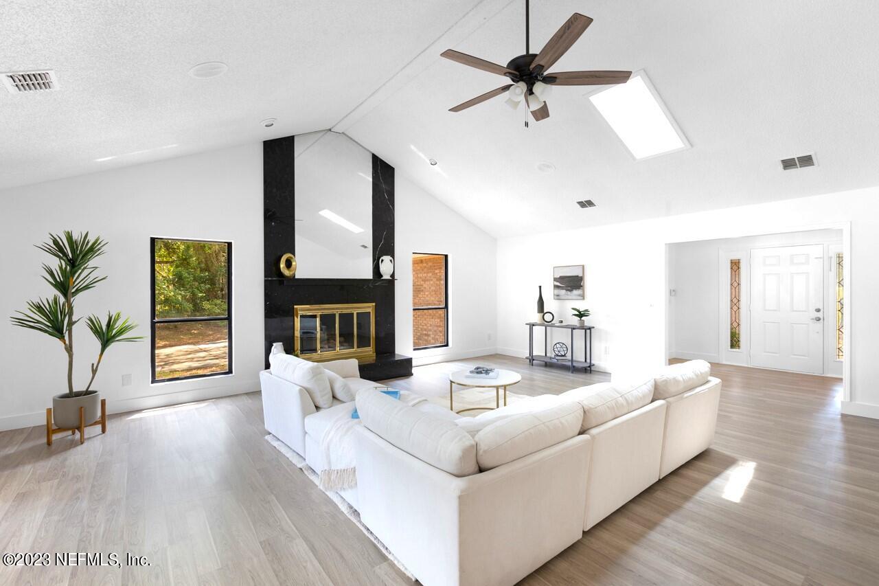 4309 Monument Road Jacksonville, FL 32225 - Photo 9 of 65 a living room with furniture fireplace and flat screen tv