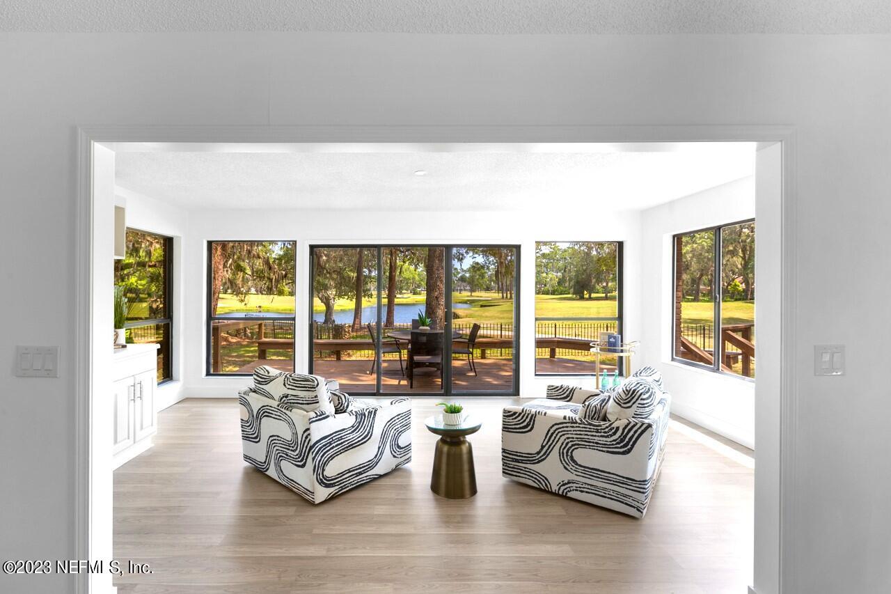 4309 Monument Road Jacksonville, FL 32225 - Photo 10 of 65 a living room with furniture and floor to ceiling windows