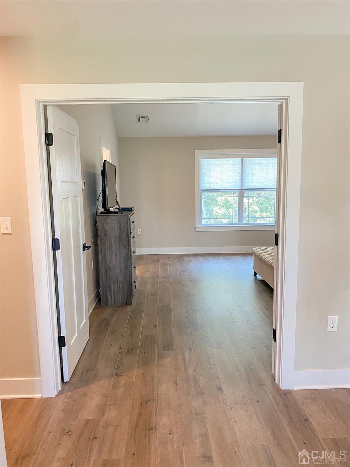 233 Privateer Road Manahawkin, NJ 08050 - Photo 22 of 47 a view of empty room with window and wooden floor