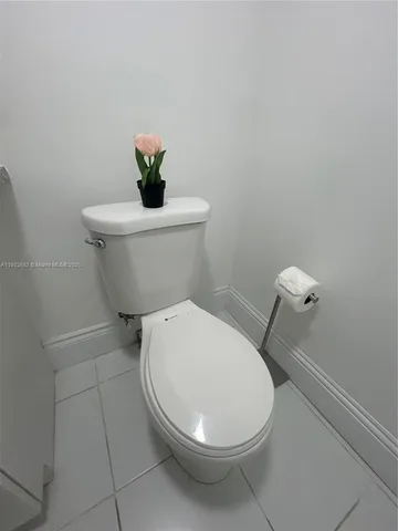 a white toilet sitting next to a bathroom sink