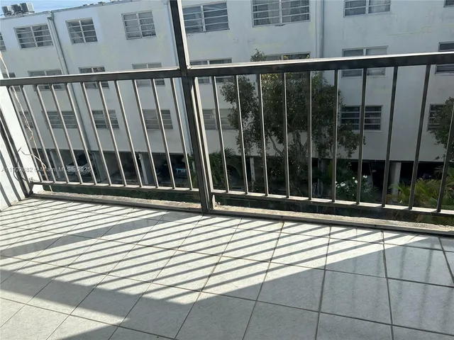 a view of entryway with a floor to ceiling window and brick wall