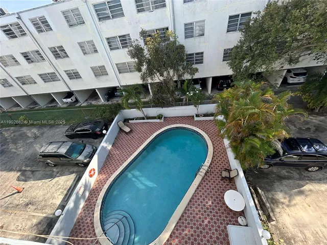 a view of a swimming pool with outdoor seating