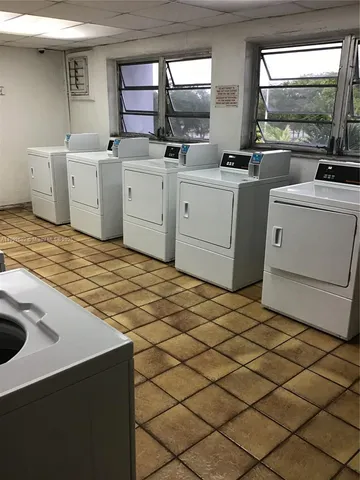 a room with a large window and furniture