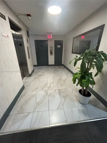 a vase of flowers sitting on a floor