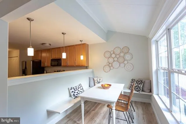 a view of a kitchen with a table and chairs