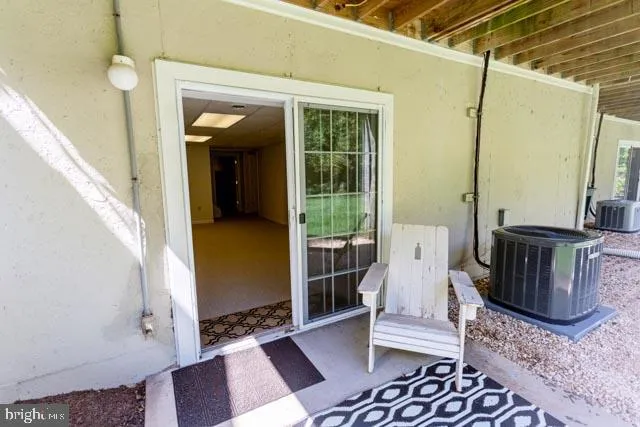 a view of a hallway with wooden floor and a couch