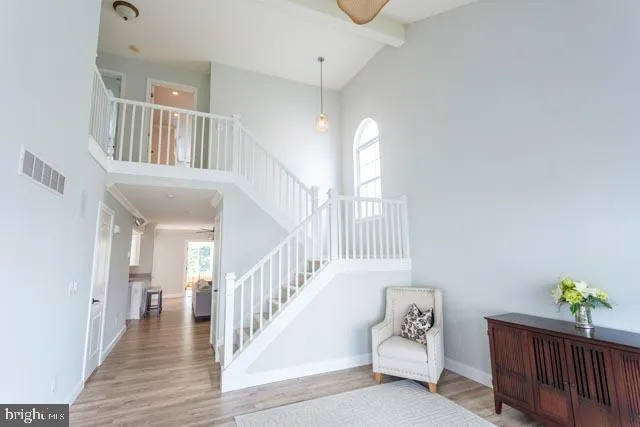 a view of entryway and hall with wooden floor