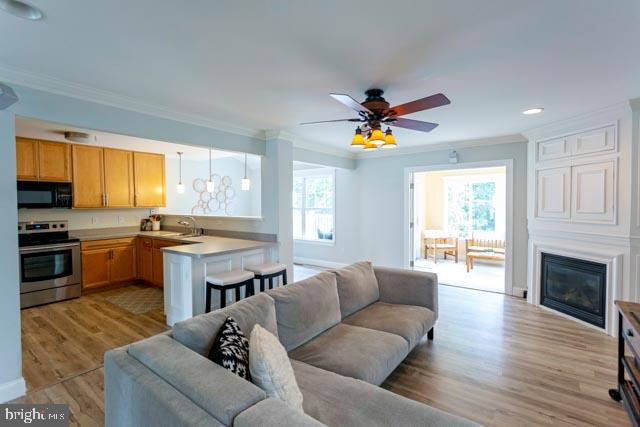 17314 King Philip Way Lewes, DE 19958 - Photo 7 of 34 a living room with stainless steel appliances granite countertop furniture a fireplace a flat screen tv and a window