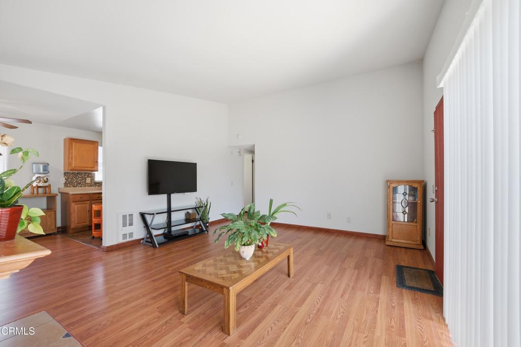 5154 Jefferson Square Oxnard, CA 93033 - Photo 6 of 23 a living room with furniture wooden floor and a flat screen tv