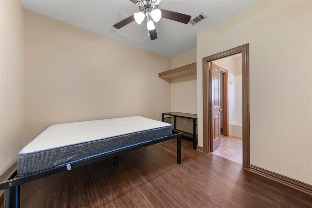 2410 South 2nd Street, Unit 1053 Waco, TX 76706 - Photo 14 of 27 Bedroom featuring wood finished floors and ceiling fan