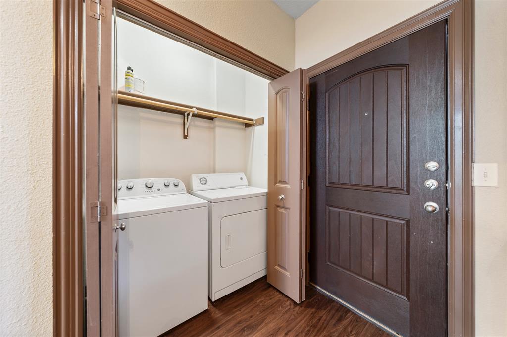 2410 South 2nd Street, Unit 1053 Waco, TX 76706 - Photo 16 of 27 Laundry area with dark wood-type flooring and washing machine and clothes dryer