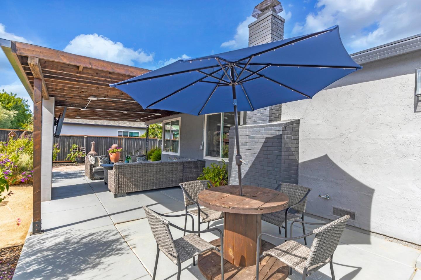 169 Turquoise Way Livermore, CA 94550 - Photo 43 of 59 a view of a patio with table and chairs under an umbrella