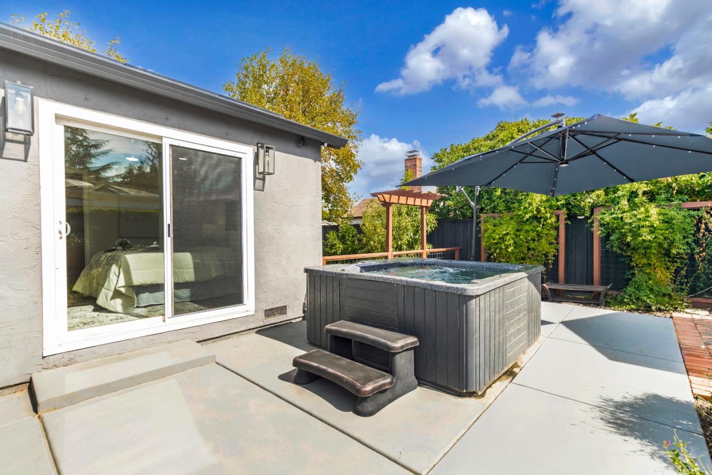 169 Turquoise Way Livermore, CA 94550 - Photo 49 of 59 a view of a backyard with a tub and table under an umbrella