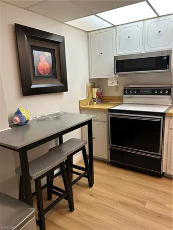 a kitchen with stainless steel appliances a stove a microwave and cabinets