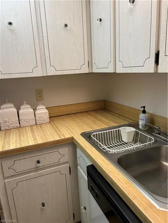 a kitchen with a sink and cabinets