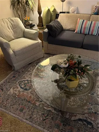 a living room with furniture and a rug
