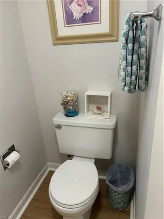 a white toilet sitting next to a bathroom sink