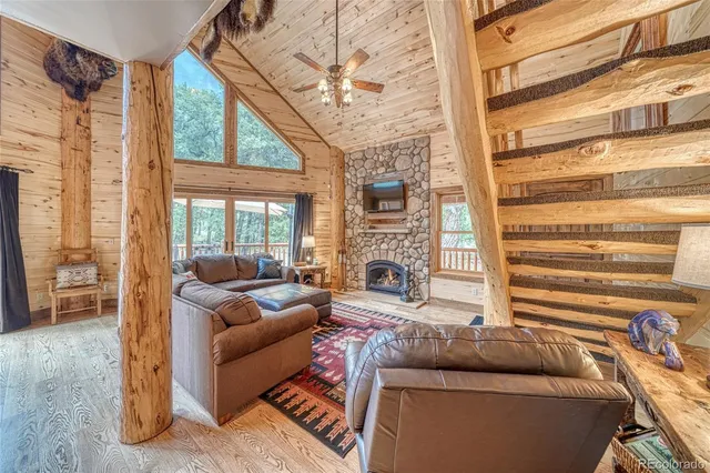 a living room with fireplace furniture and a floor to ceiling window