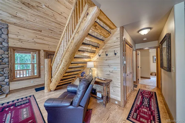a dining room with furniture a fireplace and wooden floor