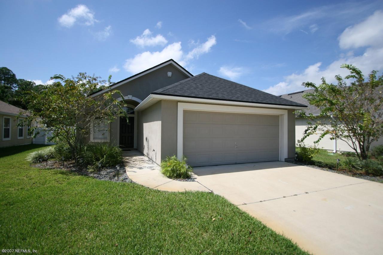 1765 Keswick Road St. Augustine, FL 32084 - Photo 1 of 12 a front view of a house with garden