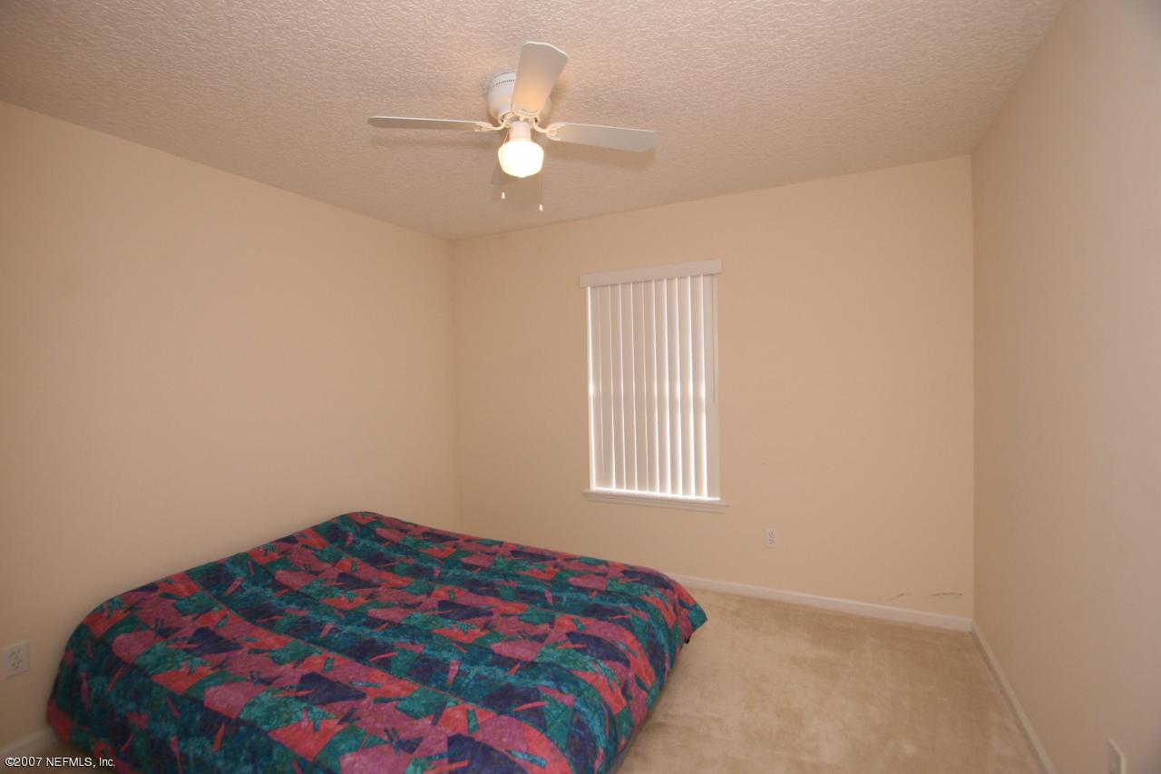 1765 Keswick Road St. Augustine, FL 32084 - Photo 8 of 12 a bedroom with a bed and a window