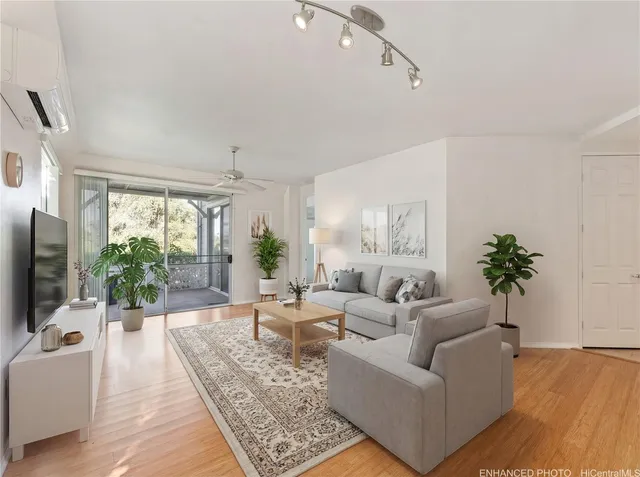 a living room with furniture large window and flat screen tv