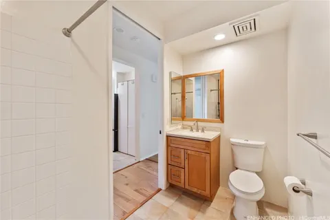 a bathroom with a toilet a sink and mirror