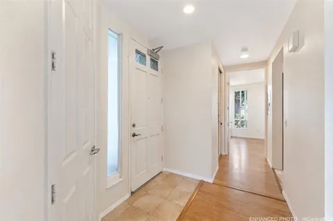 a view of a hallway with wooden floor
