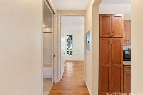 a view of a hallway with wooden floor