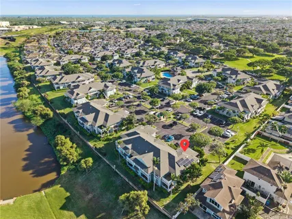 an aerial view of residential houses with outdoor space and swimming pool