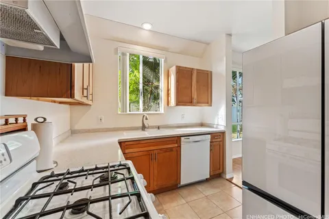 a kitchen with a sink stove top oven and cabinets