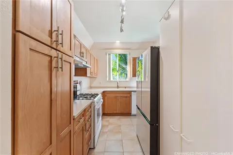 a kitchen with stainless steel appliances granite countertop a refrigerator and a sink