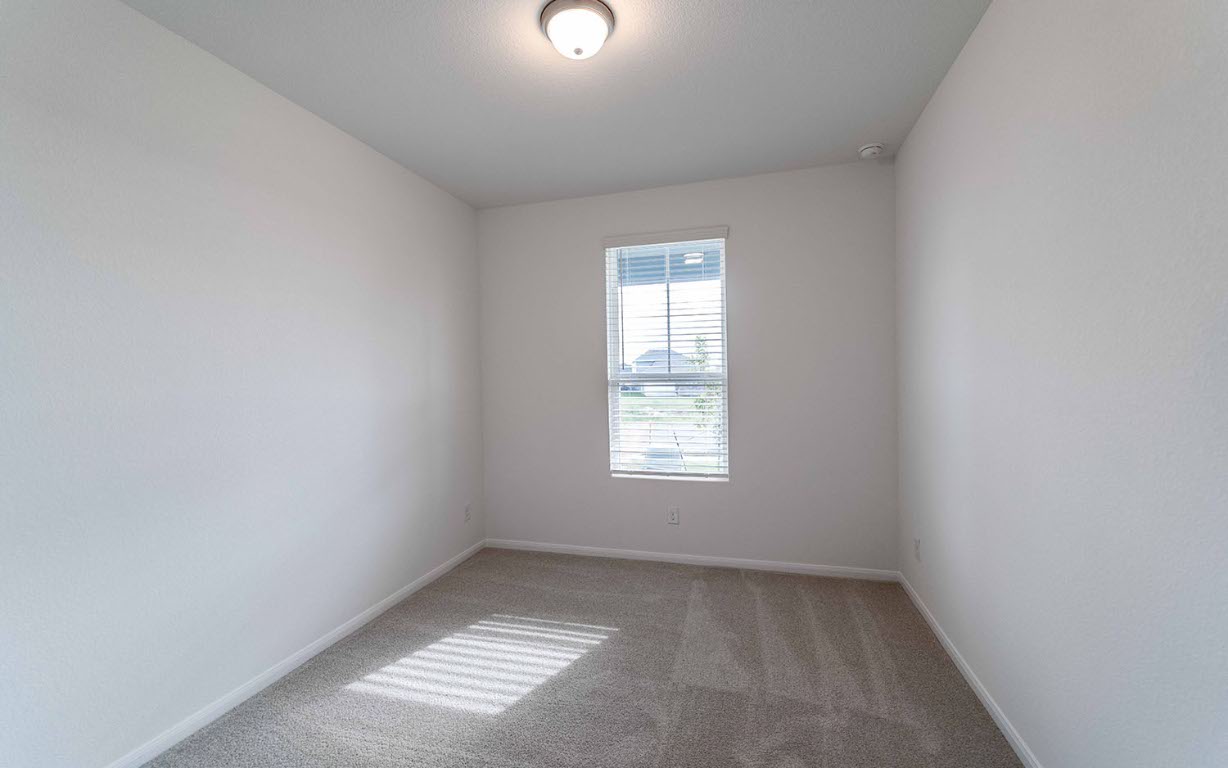290 Yosemite Drive Kyle, TX 78640 - Photo 13 of 14 an empty room with windows