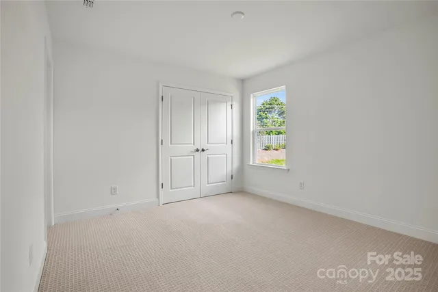 a bathroom with a granite countertop sink a toilet and a mirror