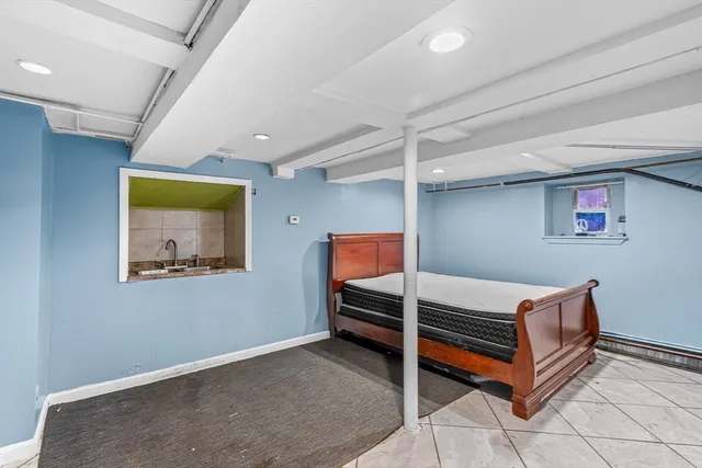 a bedroom with a bed and window