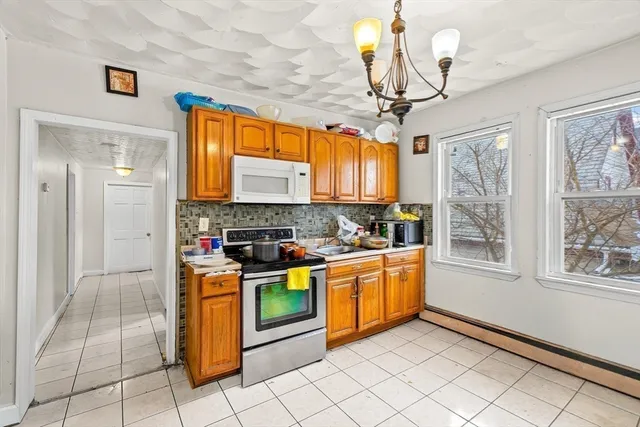a bedroom with a bed and a flat tv screen on wall