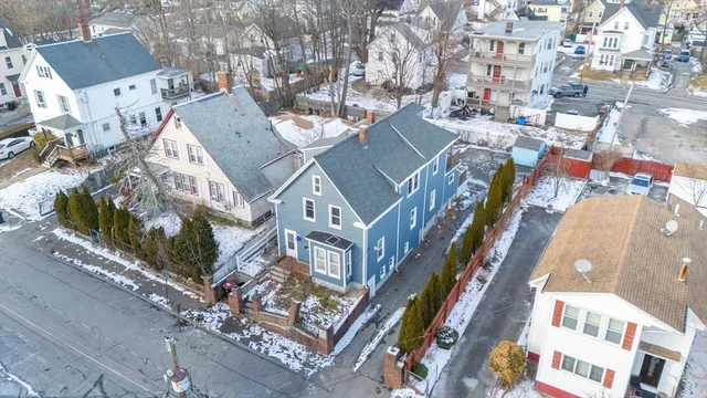 a kitchen with a dining table chairs cabinets and stainless steel appliances