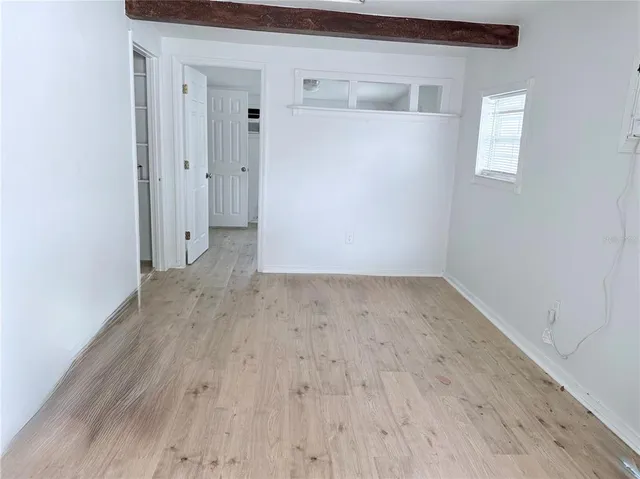 a view of a room with wooden floor