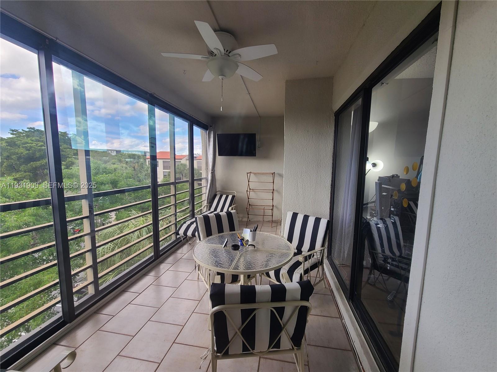2306 South Cypress Bend Drive, Unit 418 Pompano Beach, FL 33069 - Photo 11 of 18 a view of a dining room with furniture window and outside view