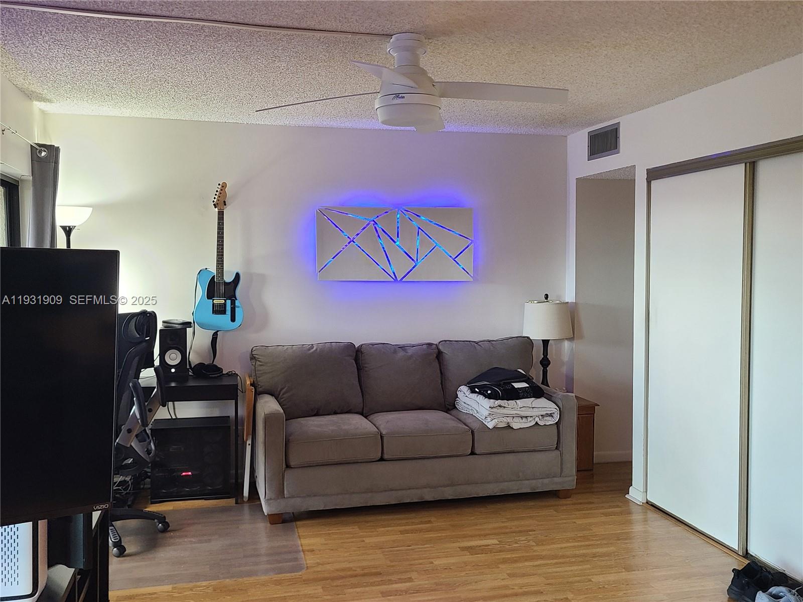 2306 South Cypress Bend Drive, Unit 418 Pompano Beach, FL 33069 - Photo 12 of 18 a living room with furniture and a flat screen tv